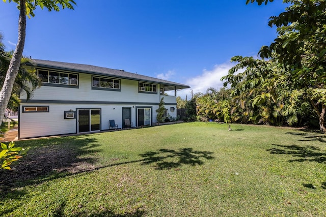 rear view of house with a yard