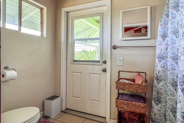 doorway to outside featuring light tile patterned flooring