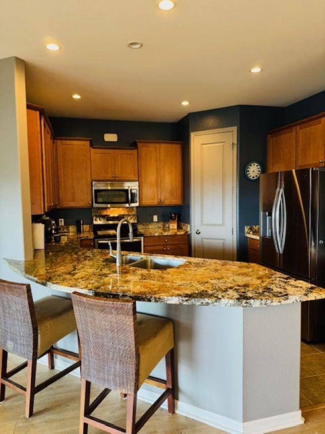 160 Kinohi Loa Loop, Wailuku, HI 96793 - kitchen with appliances with stainless steel finishes, stone counters, a kitchen breakfast bar, and recessed lighting