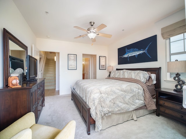 bedroom featuring ceiling fan and light carpet