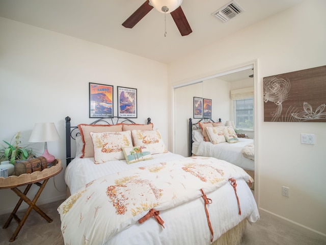 carpeted bedroom featuring ceiling fan and a closet