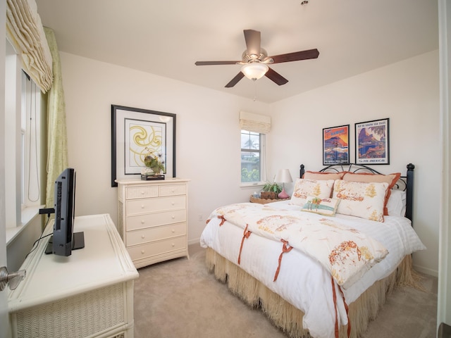 bedroom with ceiling fan and light carpet