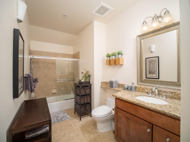 full bathroom featuring tile patterned floors, vanity, toilet, and enclosed tub / shower combo