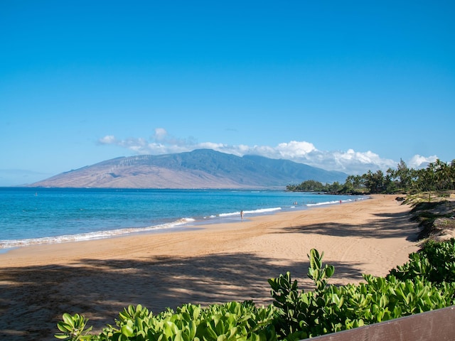 water view with a mountain view and a beach view