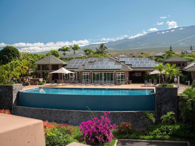 view of swimming pool featuring a mountain view and a patio