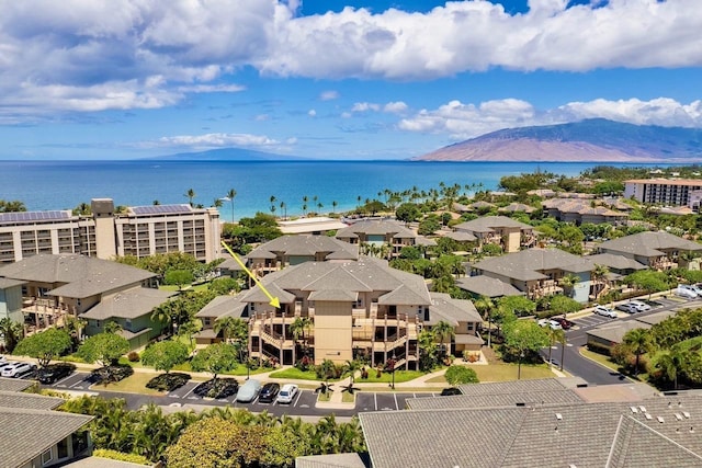 birds eye view of property with a water and mountain view