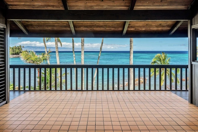 unfurnished sunroom with a water view