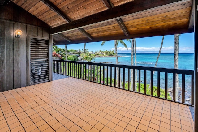 unfurnished sunroom with vaulted ceiling with beams, a water view, and wood ceiling