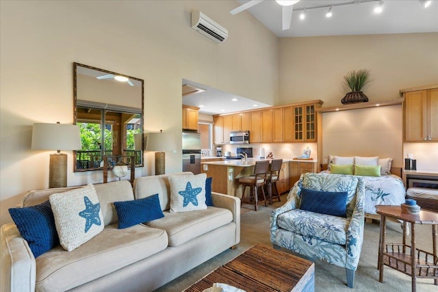 living area with light carpet, a ceiling fan, a wall mounted air conditioner, rail lighting, and high vaulted ceiling