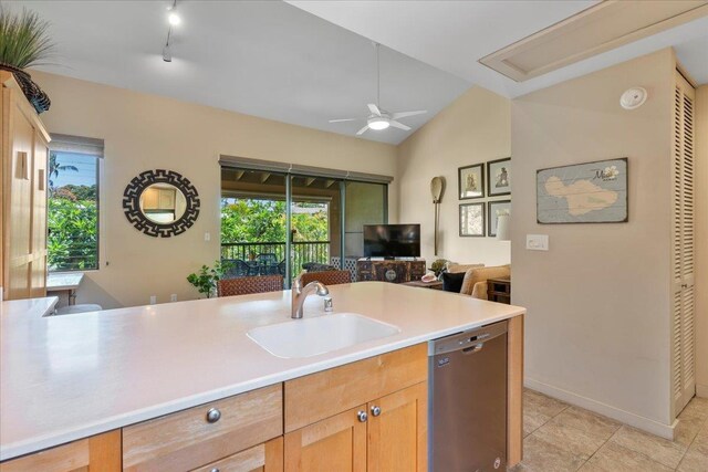 kitchen featuring light countertops, stainless steel dishwasher, a ceiling fan, open floor plan, and a sink