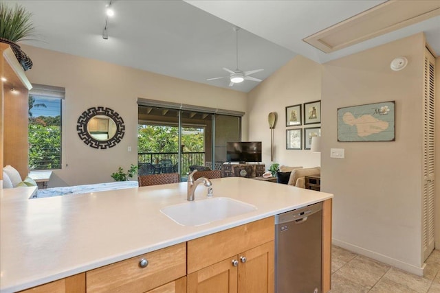 kitchen with light countertops, open floor plan, light tile patterned flooring, a sink, and dishwasher