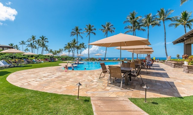 community pool featuring a yard and a patio