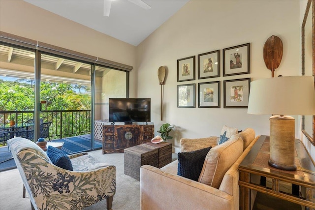 carpeted living area featuring a ceiling fan and lofted ceiling