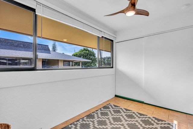 spare room featuring a ceiling fan and tile patterned floors