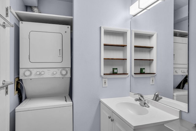bathroom featuring stacked washing maching and dryer and vanity