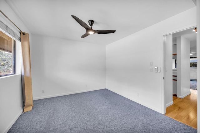 empty room with a ceiling fan, baseboards, and carpet flooring