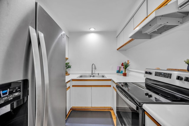 kitchen with a sink, white cabinets, under cabinet range hood, light countertops, and appliances with stainless steel finishes