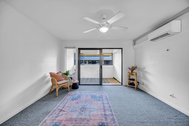 living area featuring carpet floors, baseboards, a wall unit AC, and a ceiling fan