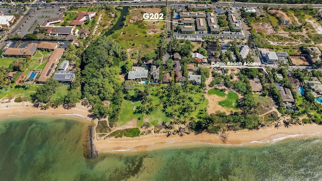 drone / aerial view with a water view, a residential view, and a beach view