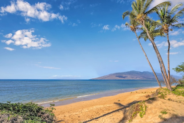 water view featuring a mountain view and a beach view