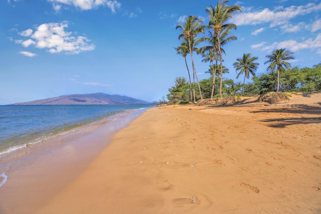water view with a beach view and a mountain view