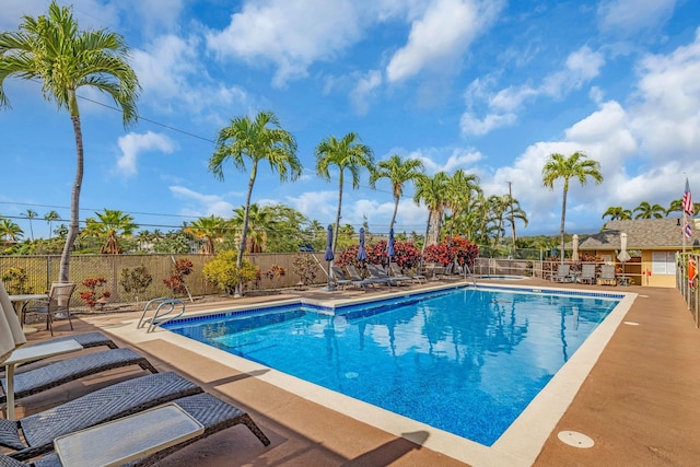 community pool featuring a patio area and fence