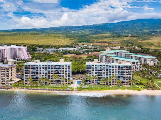 birds eye view of property with a water and mountain view