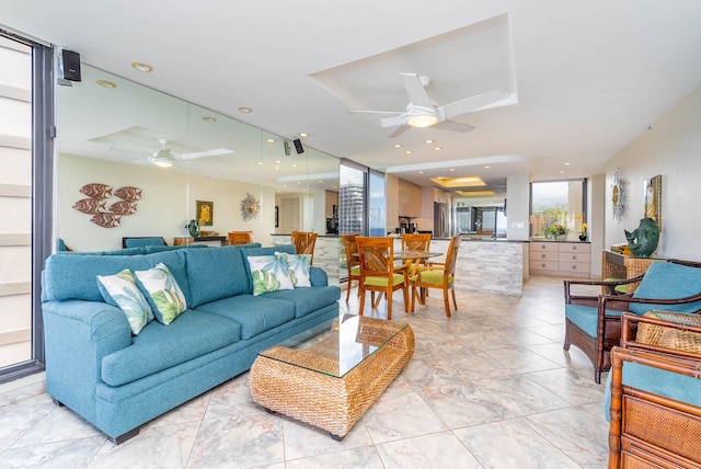 living room with ceiling fan and light tile floors