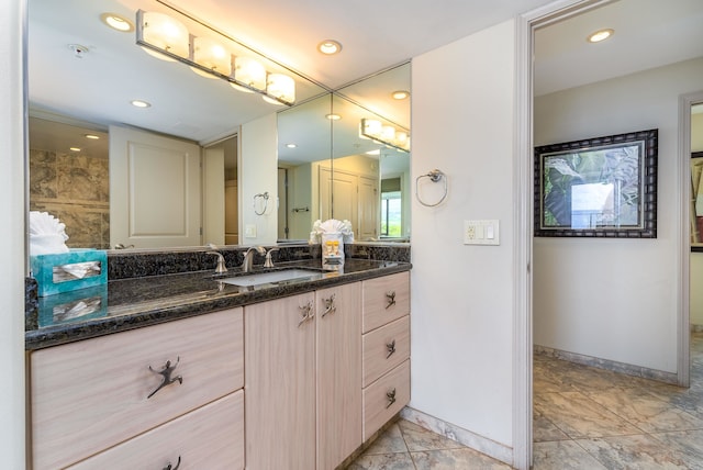 bathroom with vanity and tile flooring