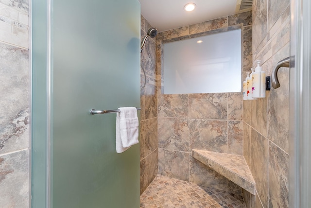 bathroom with tiled shower