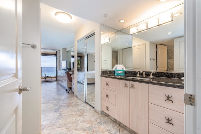 bathroom with vanity, tile floors, and a water view