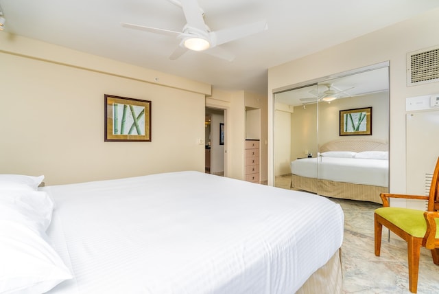 tiled bedroom with ceiling fan and a closet