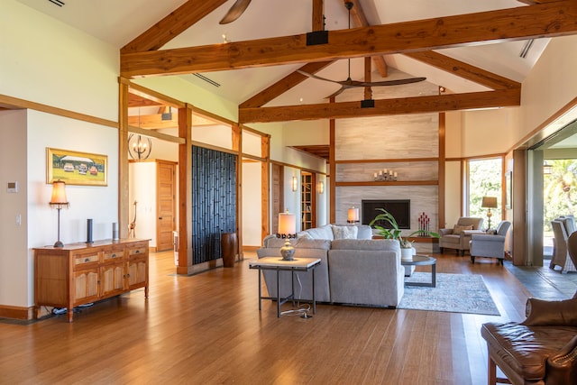 living room with high vaulted ceiling, wood-type flooring, and beamed ceiling