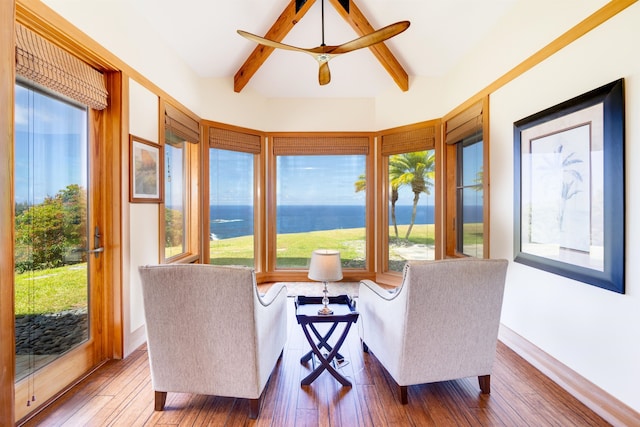 sunroom featuring beam ceiling