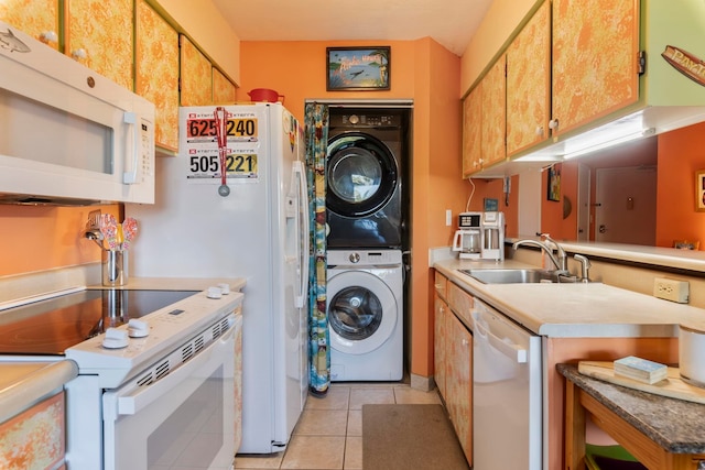 clothes washing area featuring light tile patterned flooring, stacked washer and clothes dryer, and sink