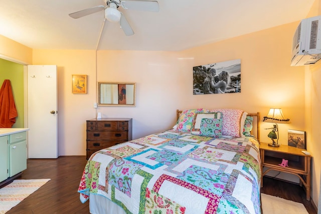 bedroom with ceiling fan, dark hardwood / wood-style floors, and a wall unit AC