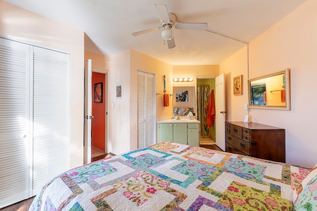 bedroom featuring connected bathroom, ceiling fan, and multiple closets