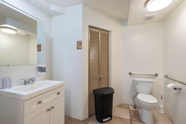 bathroom featuring tile patterned flooring, vanity, and toilet