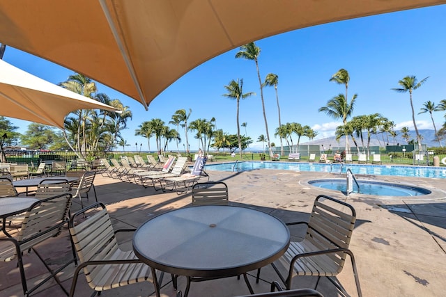 view of patio / terrace featuring a pool with hot tub