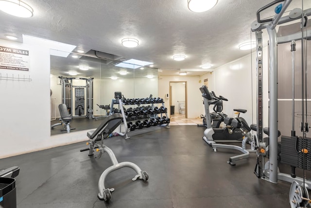 workout area featuring a textured ceiling