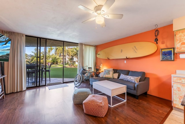 living room featuring expansive windows, hardwood / wood-style floors, and ceiling fan