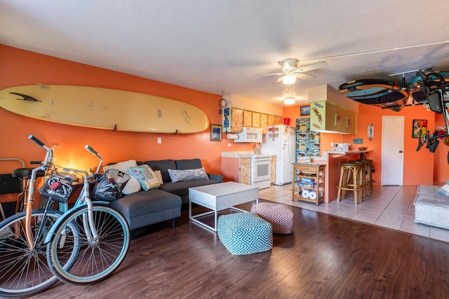 living room with hardwood / wood-style floors and ceiling fan