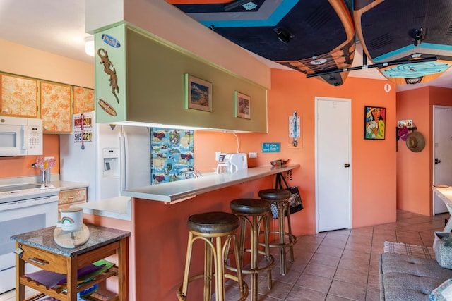 bar featuring white appliances and light tile patterned flooring