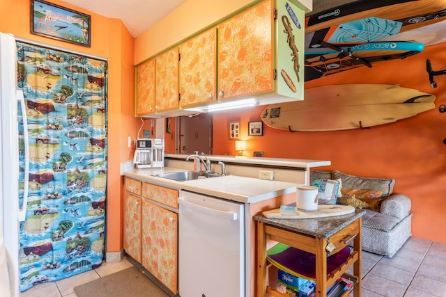 kitchen featuring dishwasher, sink, kitchen peninsula, and light tile patterned floors