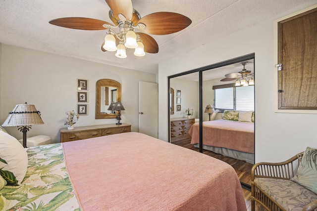 bedroom with wood-type flooring, a textured ceiling, a closet, and ceiling fan