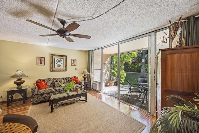 living room featuring a textured ceiling and light hardwood / wood-style floors