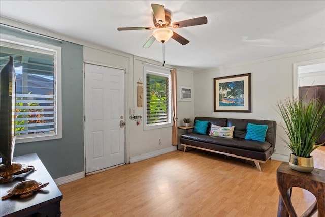 entryway with light hardwood / wood-style flooring, ceiling fan, and a wall unit AC