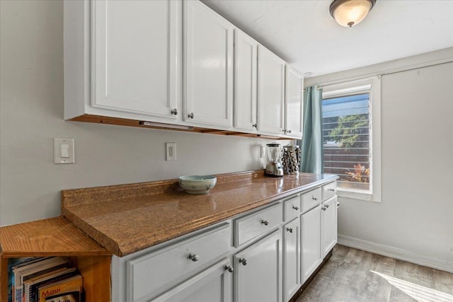 kitchen featuring white cabinets and light hardwood / wood-style flooring