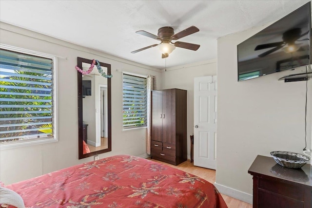 bedroom featuring light wood-type flooring and ceiling fan