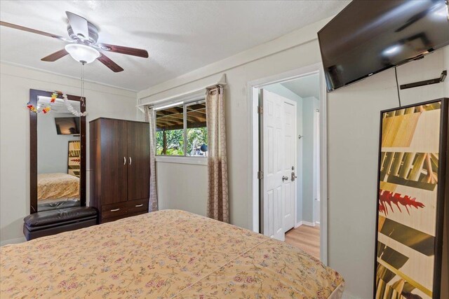 bedroom with ceiling fan and light hardwood / wood-style floors